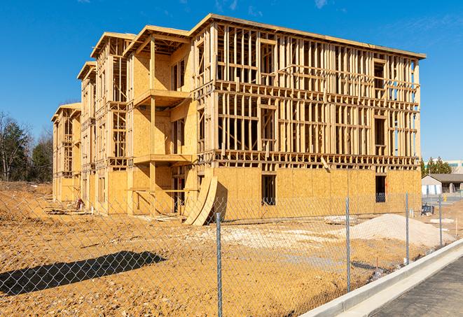 a close-up of temporary chain link fences enclosing a construction site, signaling progress in the project's development in Daly City